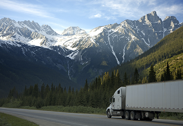 Green fuel transport truck fleet vehicle driving in mountains Green fuel transport truck fleet vehicle driving in mountains
