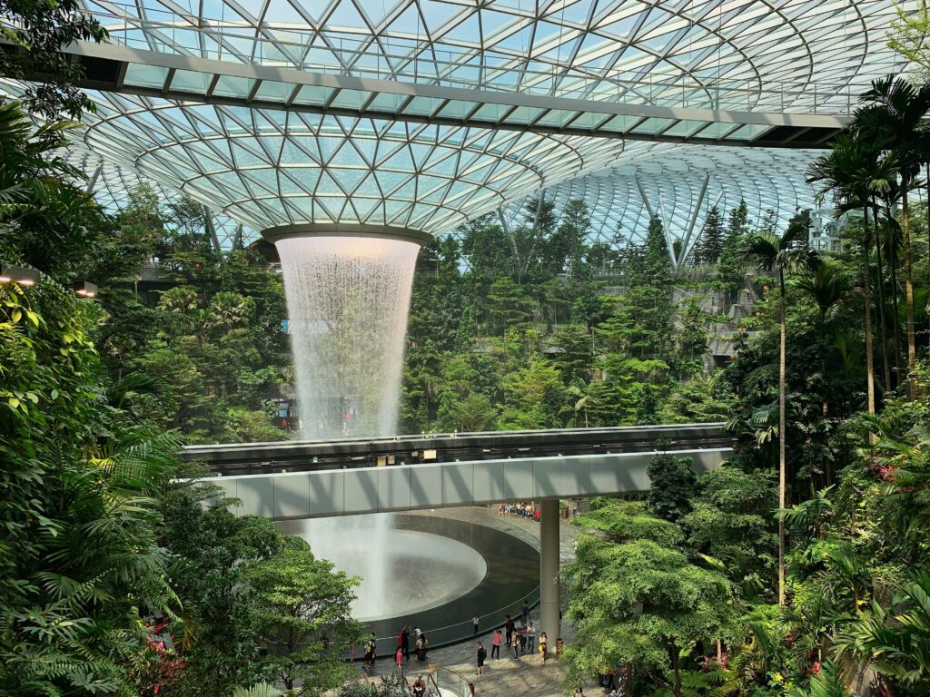 Indoor waterfall surrounded by greenery