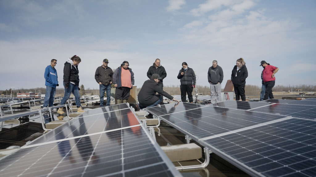 Maskwacis solar array installation with group of trainees