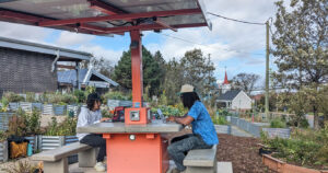 Photo of youth working at the solar awning provided to Hope Blooms by Bullfrog Power's community-based green energy projects grant