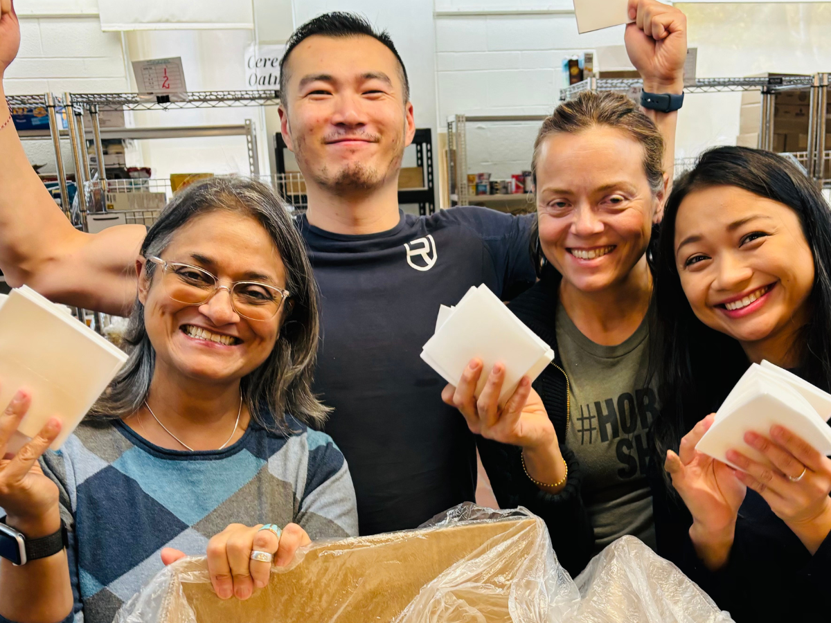 Gurbeen cropped Colleagues holding laundry sheets